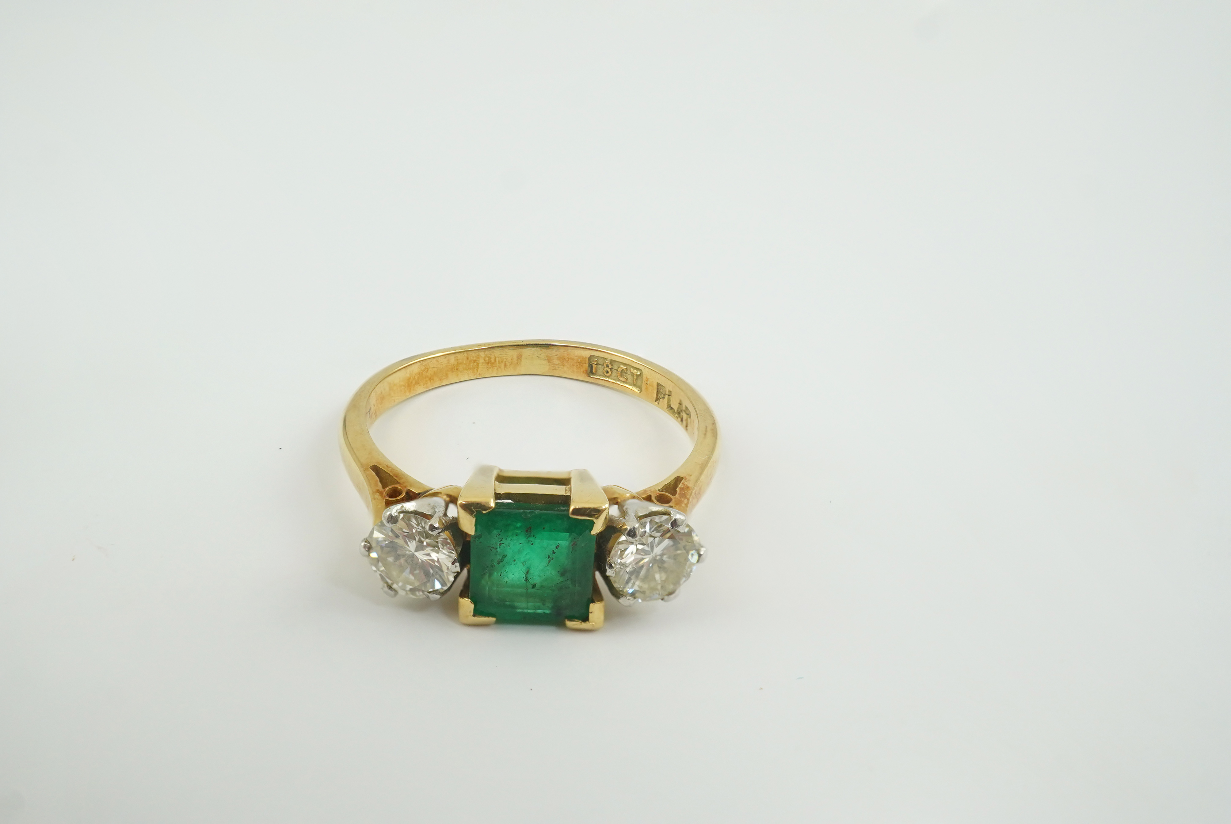 A mid 20th century 18ct gold and platinum, single stone emerald and two stone diamond set ring